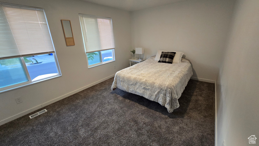 Bedroom with carpet flooring and baseboards