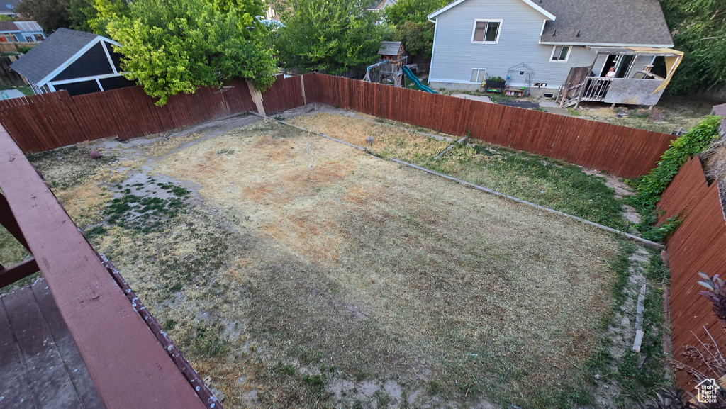 Fenced backyard with a playground