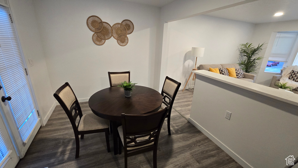 Dining space featuring dark wood-style flooring and recessed lighting