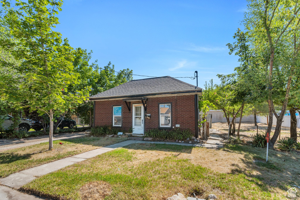 View of front of home featuring brick siding and a shingled roof