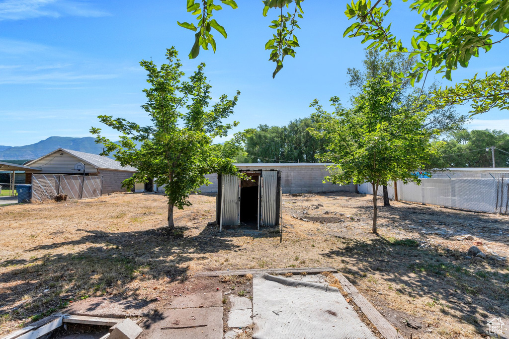 View of yard with an outdoor structure and a mountain view
