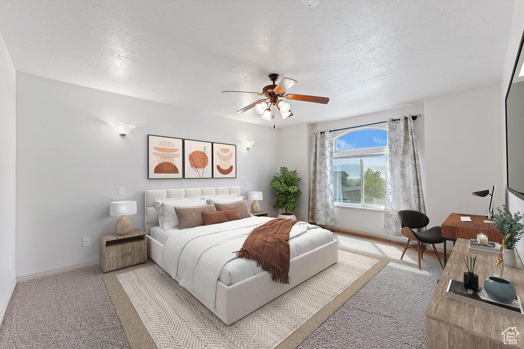 Bedroom featuring light carpet, a textured ceiling, and ceiling fan
