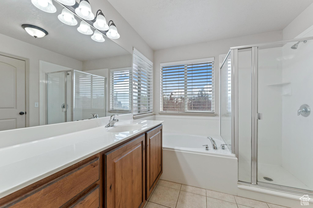 Full bathroom with a shower stall, vanity, a garden tub, and tile patterned floors