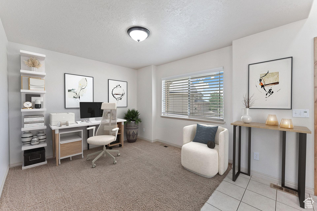 Office space featuring a textured ceiling and tile patterned floors