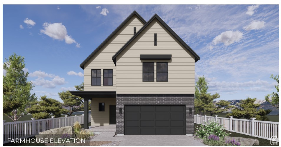View of front of house with brick siding, a garage, and driveway