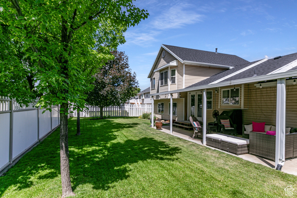 Fenced backyard featuring outdoor lounge area, a patio area, and entry steps