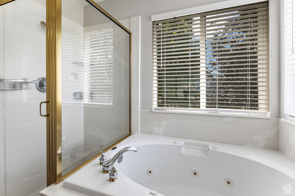 Full bath with a shower stall and a tub with jets