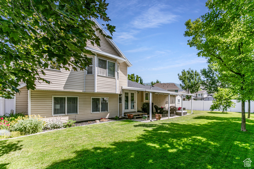 Rear view of property featuring a patio area