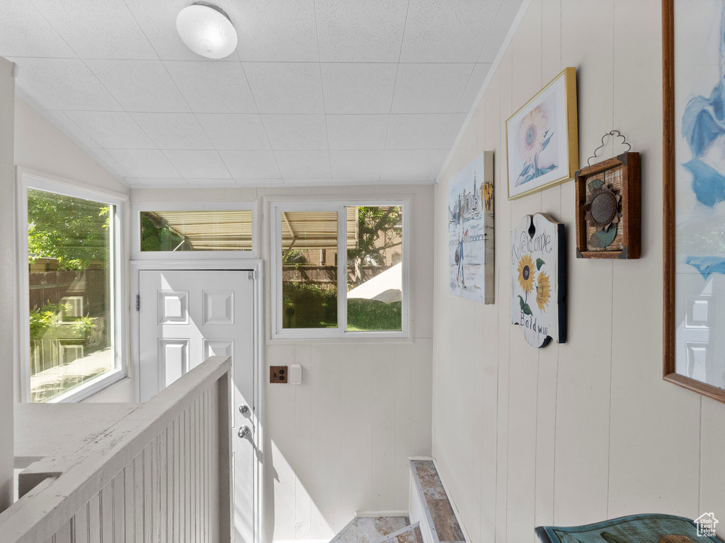 Stairway featuring lofted ceiling