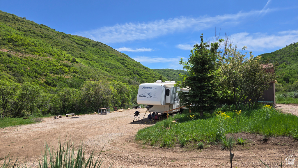 View of mountain backdrop featuring a heavily wooded area