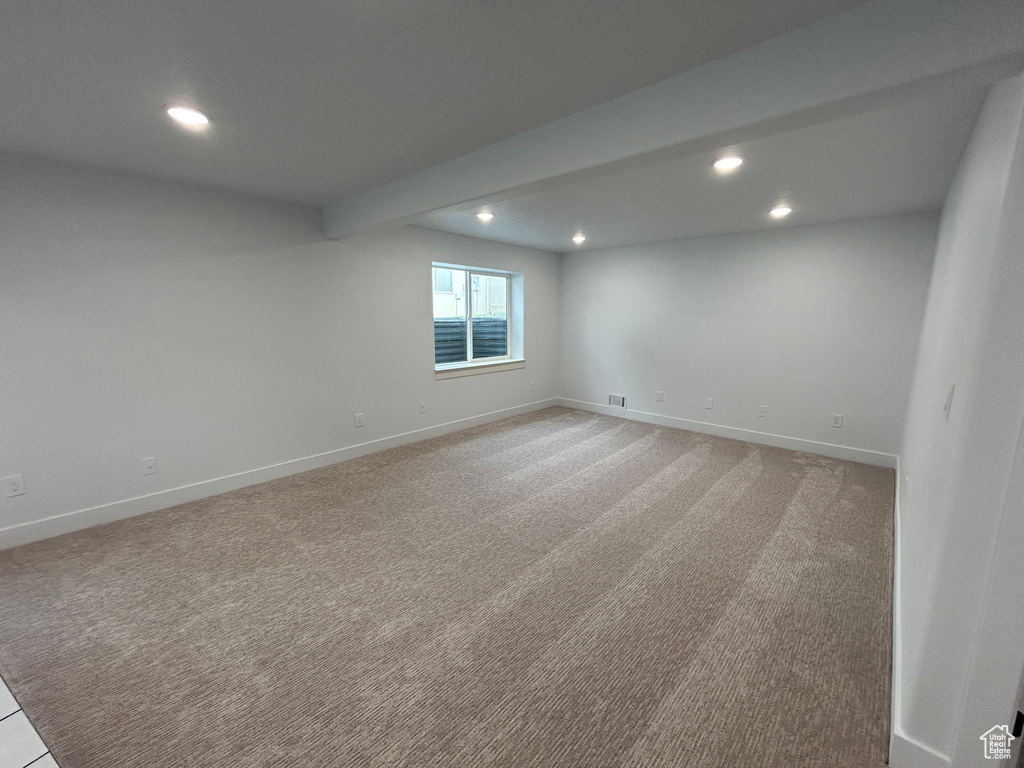 Spare room featuring recessed lighting and light carpet