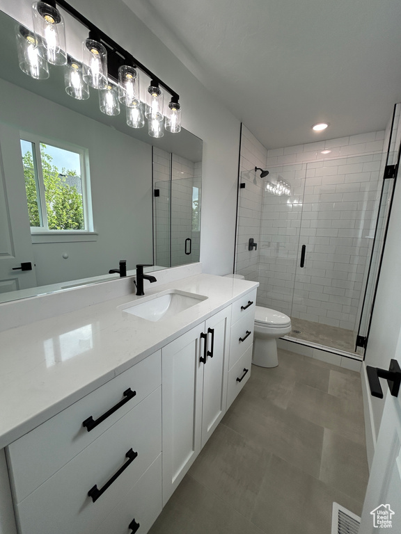 Bathroom featuring vanity and a stall shower