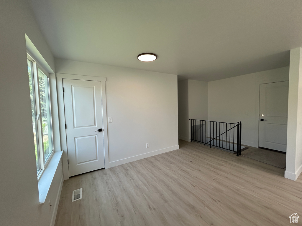 Empty room with light wood-type flooring and baseboards