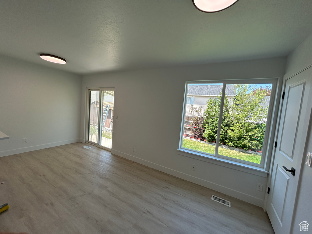 Empty room with baseboards and light wood finished floors