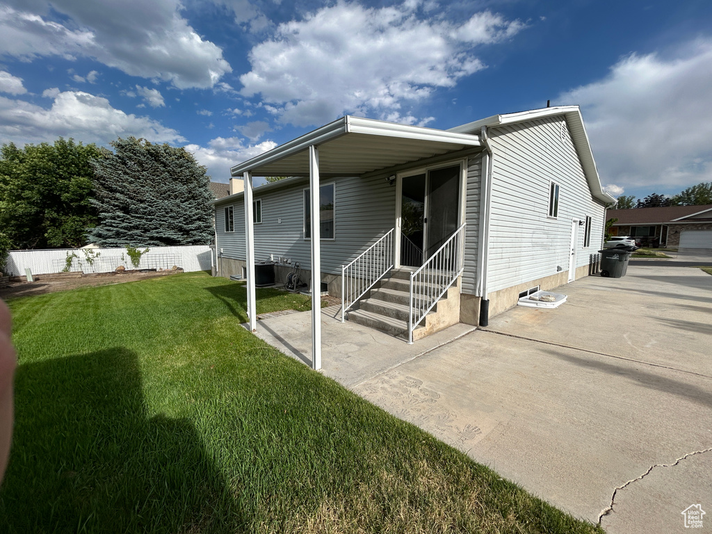 Rear view of property with entry steps and a patio area