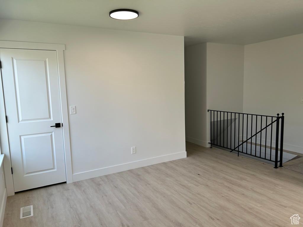 Empty room with wood finished floors and baseboards