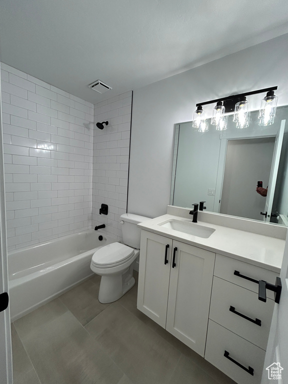 Full bath featuring vanity, shower / bath combination, and tile patterned floors
