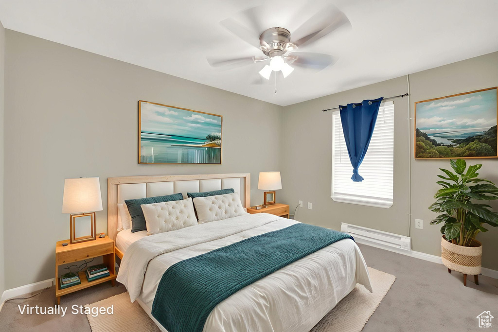 Bedroom featuring a baseboard heating unit, carpet, and a ceiling fan