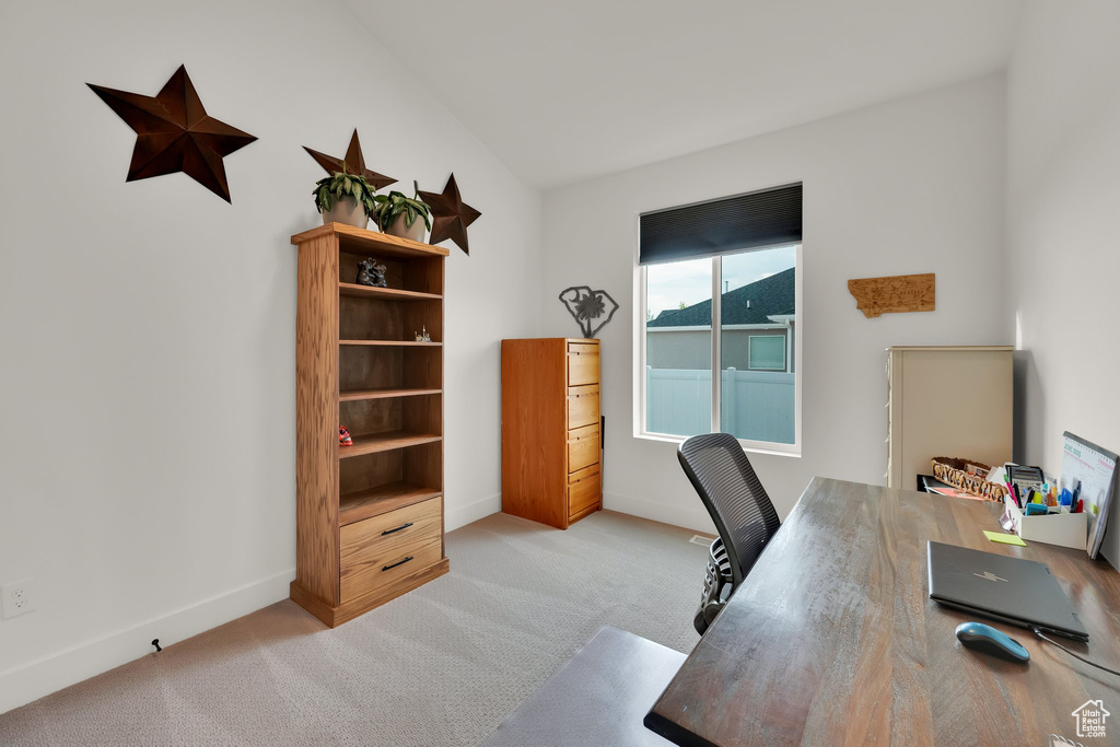Office space with light colored carpet and baseboards