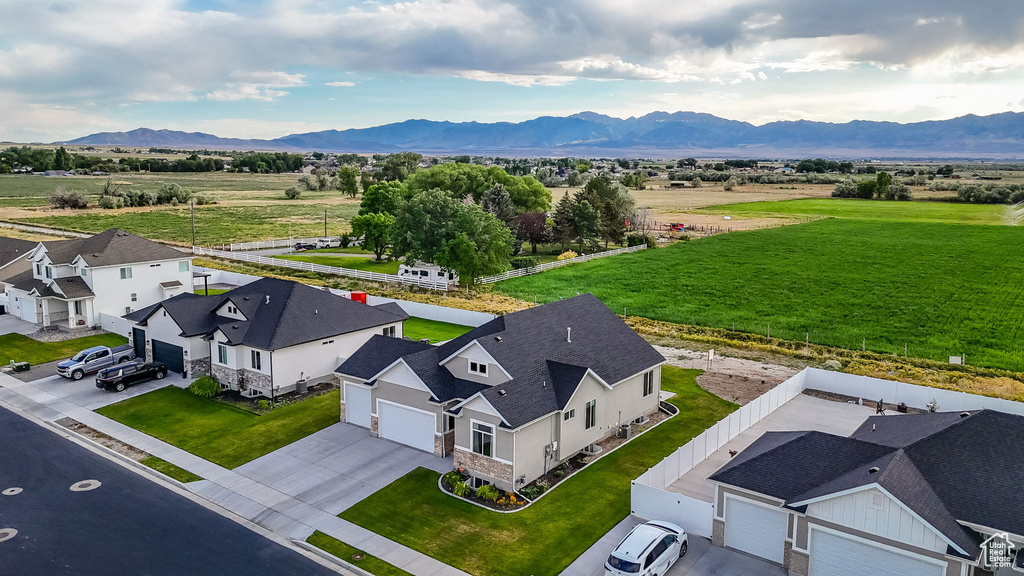Overview of rural landscape featuring a mountain backdrop and nearby suburban area