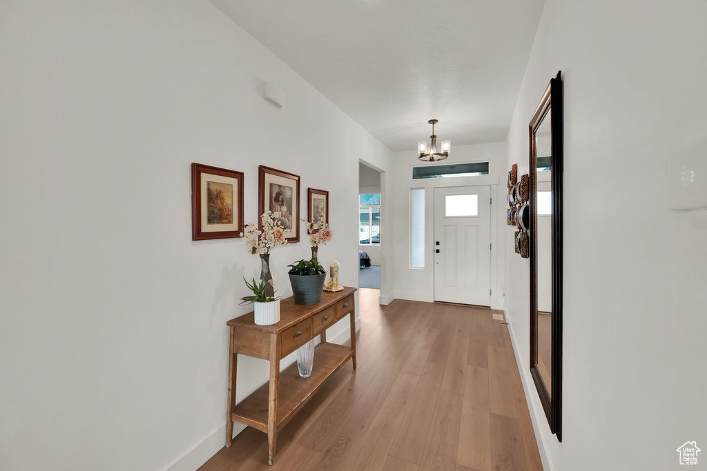 Foyer featuring a chandelier and light wood-type flooring