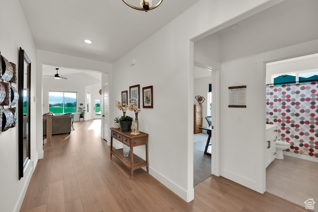 Corridor featuring light wood-type flooring and recessed lighting