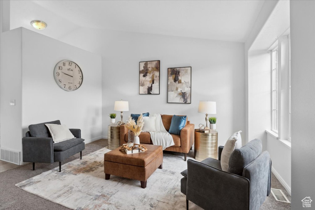 Living room with vaulted ceiling and carpet flooring