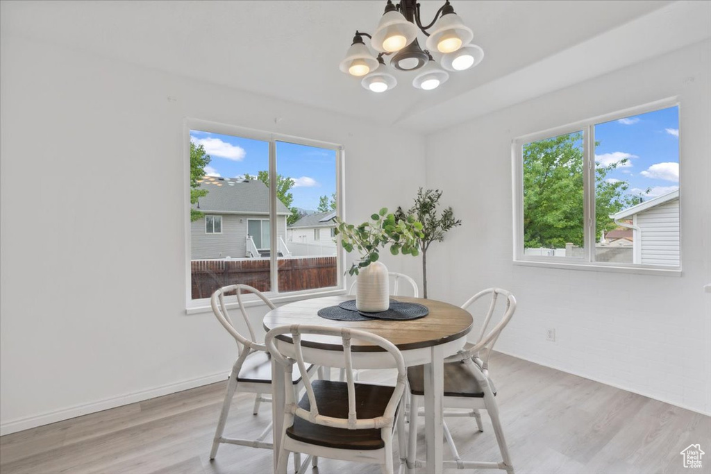 Dining area featuring a chandelier and light wood-style floors