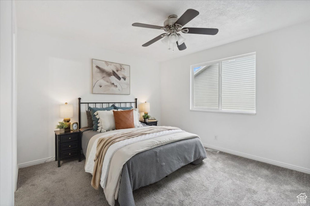 Bedroom with carpet floors and a ceiling fan