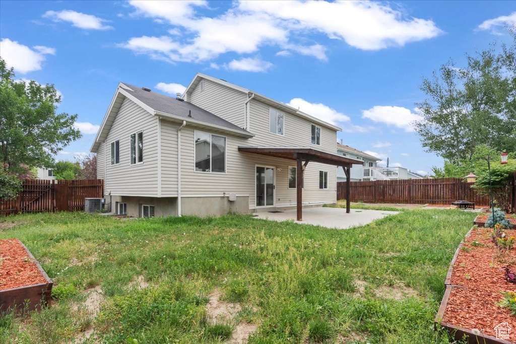 Back of property featuring a patio and a fenced backyard
