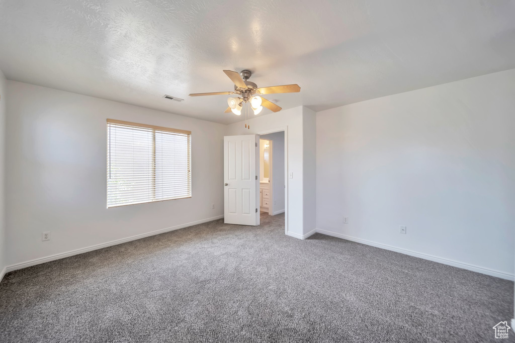 Unfurnished bedroom featuring carpet flooring and ceiling fan