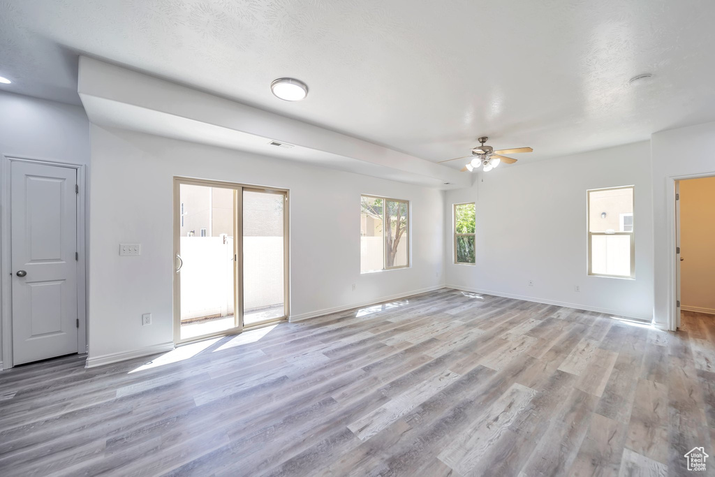 Unfurnished living room featuring ceiling fan and light wood finished floors