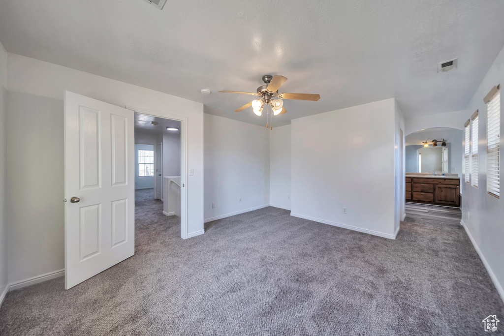 Unfurnished bedroom with carpet floors and ceiling fan