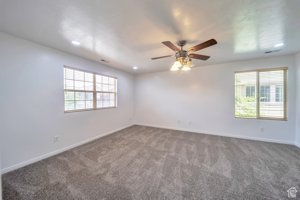 Carpeted spare room with ceiling fan, healthy amount of natural light, and recessed lighting