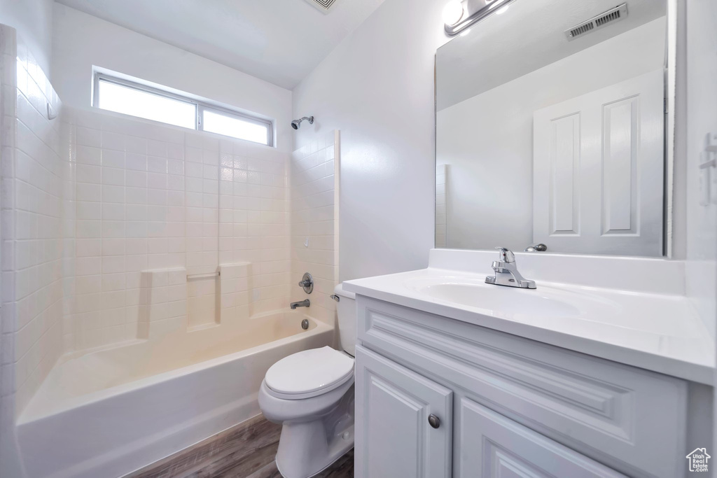 Full bathroom featuring vanity, tub / shower combination, and wood finished floors