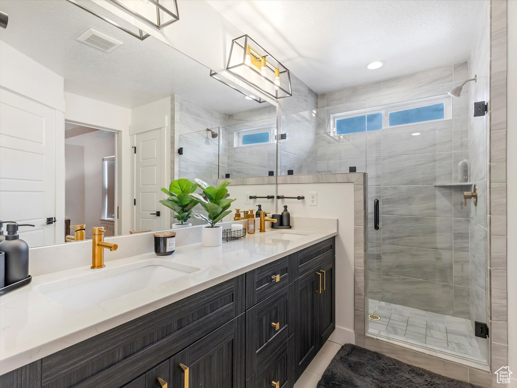 Bathroom with double vanity and a shower stall