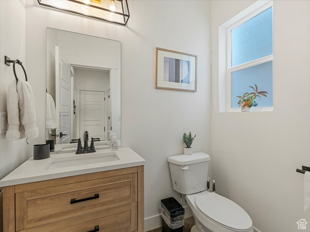 Half bathroom featuring toilet and vanity