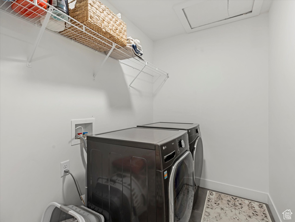 Laundry area featuring washer and dryer and attic access