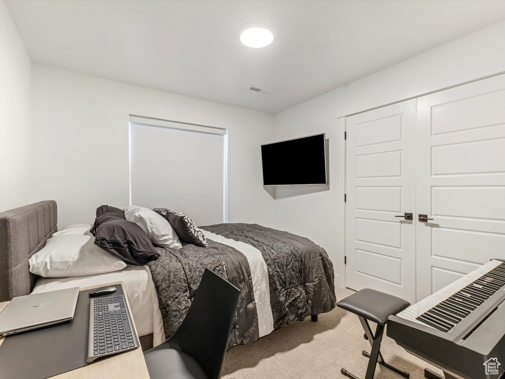 Carpeted bedroom featuring a closet