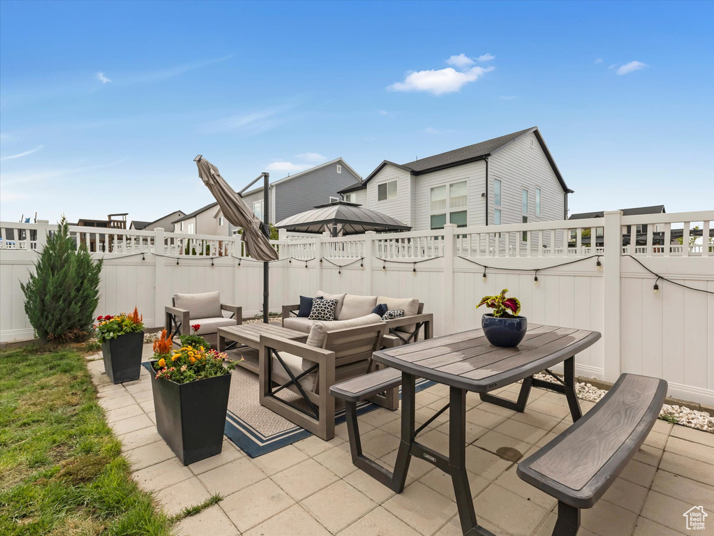 Fenced backyard featuring an outdoor living space and a patio