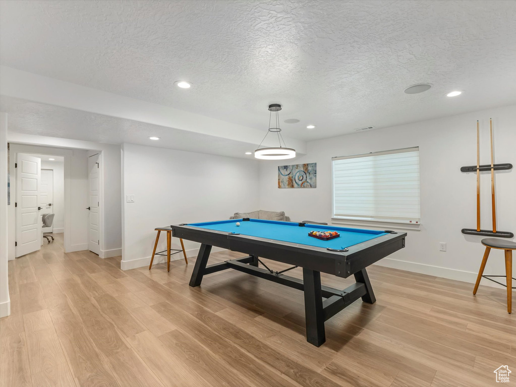 Recreation room featuring a textured ceiling, pool table, light wood-type flooring, and recessed lighting