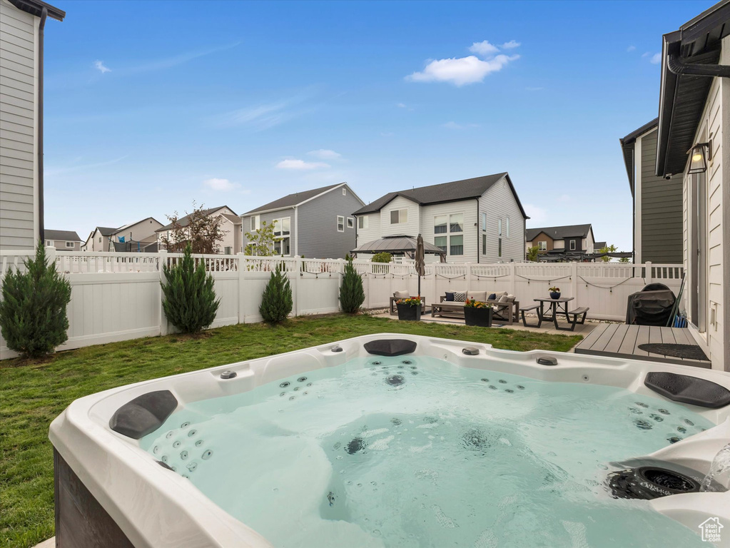 View of pool with a hot tub, a residential view, and a wooden deck