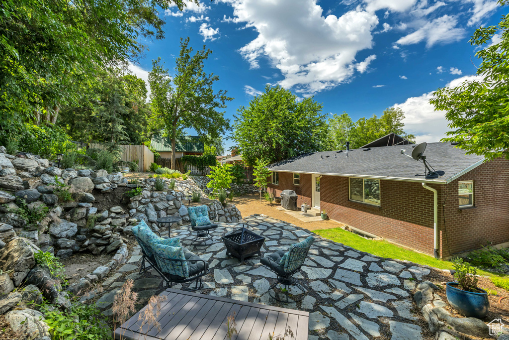 View of patio / terrace featuring an outdoor fire pit
