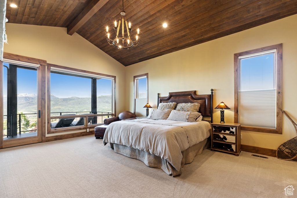 Carpeted bedroom with access to outside, a chandelier, a mountain view, recessed lighting, and wooden ceiling
