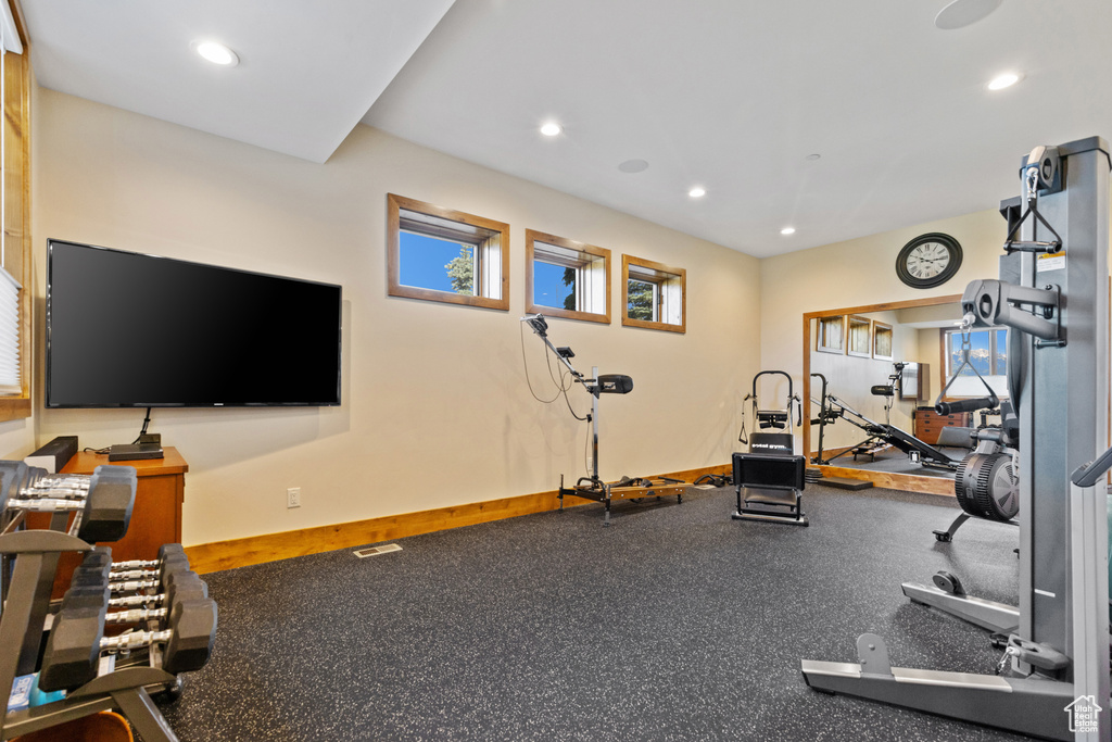 Exercise room with recessed lighting and baseboards