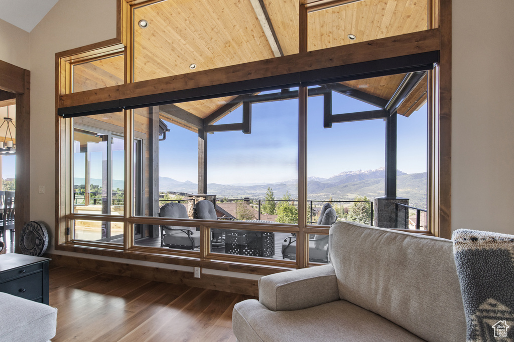 Living area with a mountain view, wood finished floors, and plenty of natural light