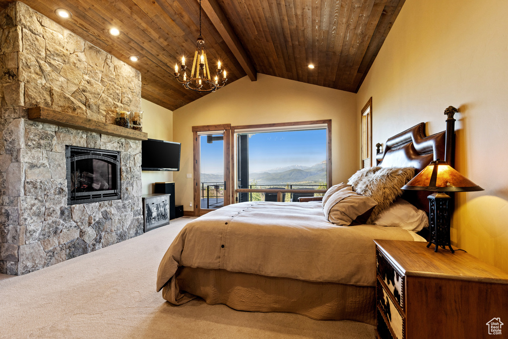 Carpeted bedroom featuring access to exterior, a chandelier, wooden ceiling, a fireplace, and recessed lighting