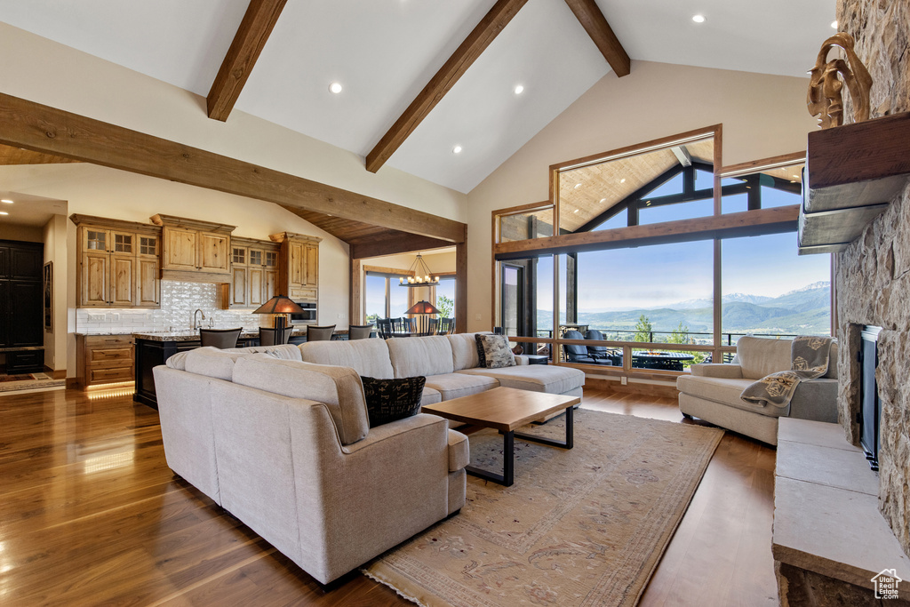 Living area featuring beam ceiling, dark wood finished floors, high vaulted ceiling, and recessed lighting