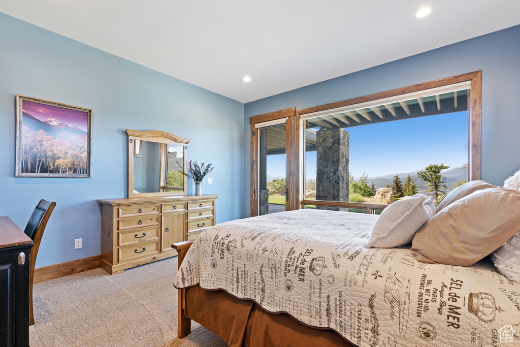 Bedroom featuring light colored carpet, recessed lighting, and a mountain view