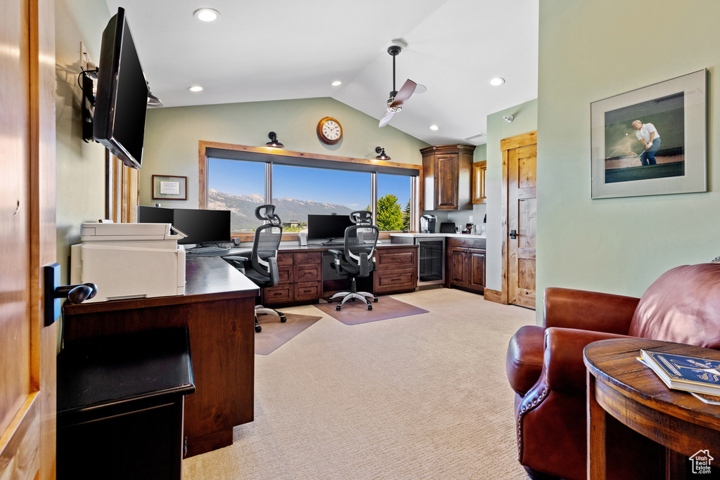 Office with wine cooler, lofted ceiling, light carpet, a ceiling fan, and recessed lighting